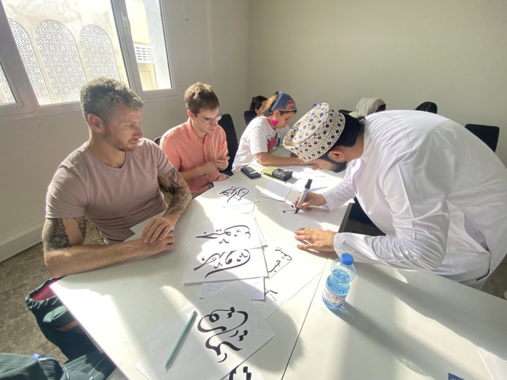 Noor Majan students attend an Arab calligraphy workshop hosted by a local calligraphist at our institute. They are practicing writing their names in Arabic.